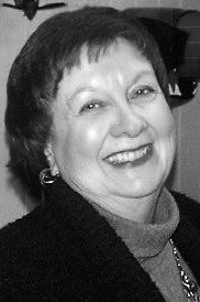 Smiling elderly woman in black and white photo.