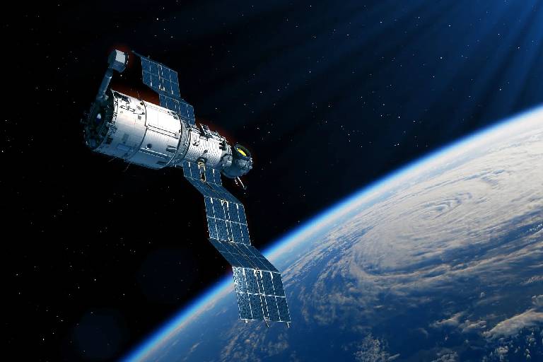 Satellite orbiting Earth with solar panels extended.